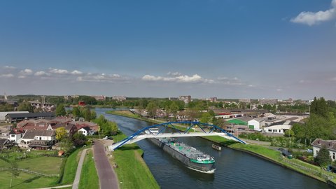 ZWOLLE, NETHERLANDS - MAY 6, 2022: Freight ship barge sailing on the Zwolle-IJssel canal in the port of Zwolle seen from above