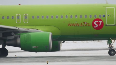 NOVOSIBIRSK, RUSSIA - JANUARY 22, 2017: Airbus A320 of S7 Airlines passenger plane on the runway at Tolmachevo Airport on a winter day