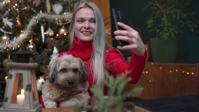A woman takes a selfie together with her dog on Christmas Day.