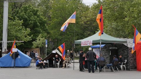 Yerevan, Armenia - May 9, 2022: Protesters against Pashinyan's government set up tents with flags on the square and collect signatures of citizens for the resignation of the Prime Minister