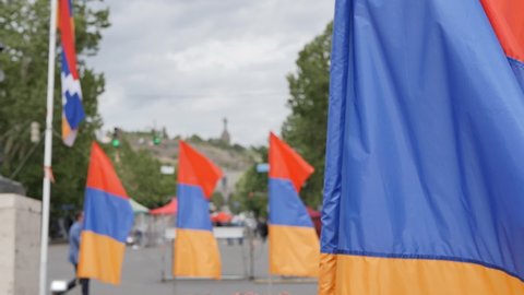 Armenian flags in the wind movement. Lots of Armenian flags on the square. DOF, slow motion