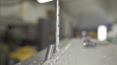 Closeup Of A Drill Bit Drilling Aluminium In A Industrial Manufacturing Workshop