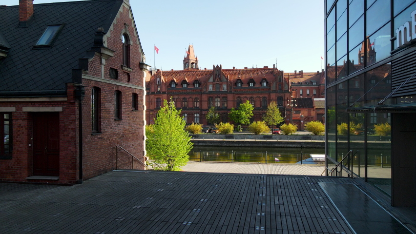 Dolly forward shot of Brda River and famous Main Post Office Building during summer - Bydgoszcz,Poland