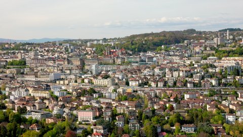 Local Train Arriving At Lausanne Railway Station With A View Of Lausanne City In Vaud, Switzerland. - aerial