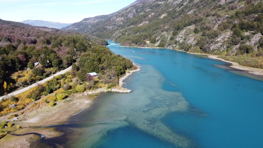 Top Aerial Drone View of the impressive Baker River and Carretera Austral road. Bird Eye View over Turquoise Cristal Clear Water in Patagonia, Chile.