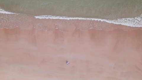 Overhead Drone Flight Rising From Woman Lying On Beach Towel On Nacpan Beach, Palawan Island, Philippines