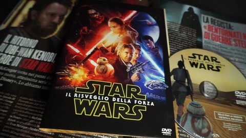 Rome, Italy - May 09, 2022, detail of the cover and dvd of the movie Star Wars the awakening of the Force, in the background the cinema magazine Ciak with a special on the new Obi Wan Kenobi series.