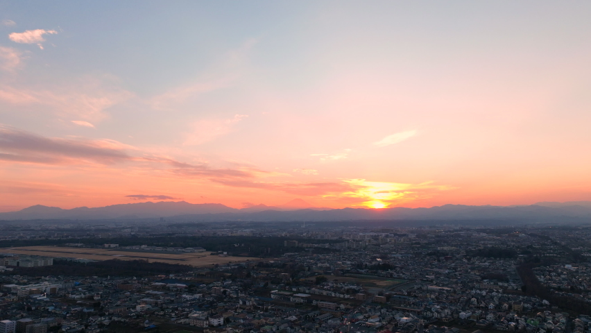 The view of sunset from the sky and Mt. Fuji. This is a unique combination of the cityscape, the setting sun, and Mt. Fuji. Royalty-Free Stock Footage #1090220367
