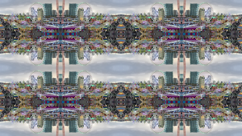 A timelapse of the lit up rides at a funfair in barcelona made into abstract mirrored pattern 
