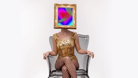 Amazing female with a gold picture frame as a head sitting in a transparent chair. In the frame is a pumping heart video