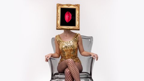 Amazing female with a gold picture frame as a head sitting in a transparent chair. In the frame are moving red lips