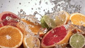 Slow Motion Shot of Citrus Fruits and Water Splashing through Lemon, Lime, Grapefruit Slices - Powered by Shutterstock - Get 15% off with code: PIKWIZARD15