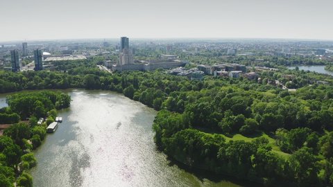 4k video. Bucharest from above, aerial view over Herastrau (King Michael I) Park, lake and the north part of the city with office building photographed during a summer sunny day.