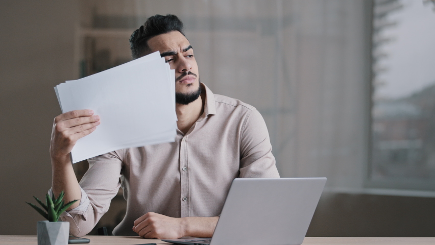 Hispanic exhausted male business man annoyed guy suffer from summer heat in office home without air conditioner feeling hot high air temperature uncomfortable waving papers cooling make wind freshen Royalty-Free Stock Footage #1090223639