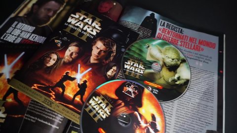 Rome, Italy - May 09, 2022, detail of the cover and dvd of the movie Star Wars III, Revenge of the Sith, and in the background the cinema magazine Ciak with a special on the new Obi Wan Kenobi series.