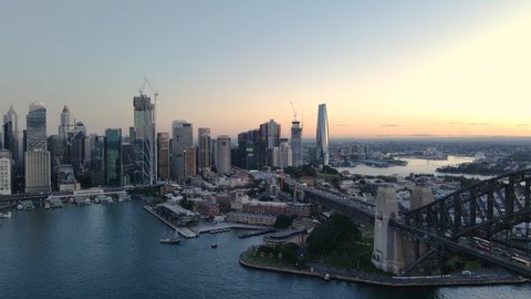 SYDNEY, NSW, AUSTRALIA – MAY 6, 2022: Aerial drone view of Sydney City passing by Circular Quay on Sydney Harbour in the late afternoon     