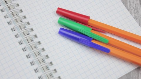 Red blue and green pen close-up.Ballpoint pens and notepad.Stationery pens and notebook.