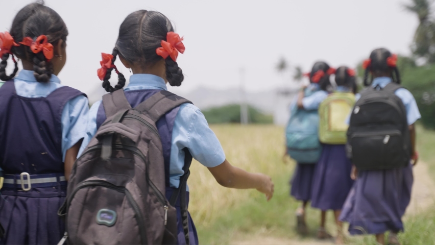Back view shot of village kids in uniform going home from school after class - concept of education, childhood lifestyle and friendship Royalty-Free Stock Footage #1090230095