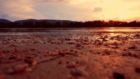 Beautiful sunset over the river waves. 4K video, sunset, river