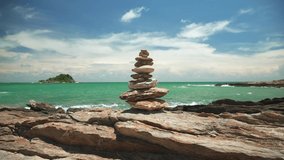 Stones balance on reef rock with a background of sea and blue sky on summer season, Stone tower balance.