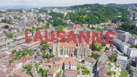 Inscription on video. Lausanne, Switzerland. Cathedral of Lausanne. La Cite is a district historical centre. On the mechanical display, Aerial View, Departure of the camera
