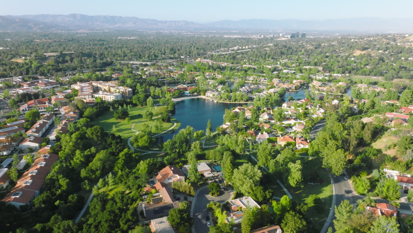 Houses at Calabasas lake, suburban neighborhood Los Angeles, San Fernando Valley, California, USA. Drone footage of the community in the coastal city. High quality 4k footage