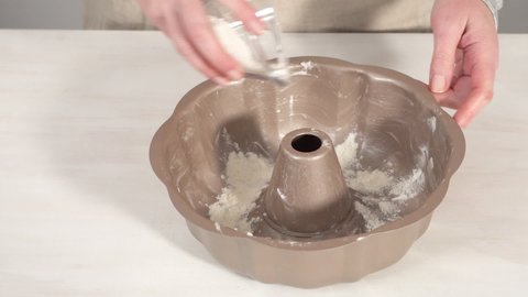 Step by step. Greased metal bundt cake pan to bake chocolate bundt cake with chocolate frosting.