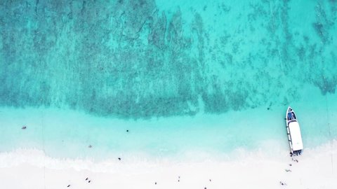 Aerial video of the Andaman Sea, sea waves approaching the paradise beach. Impressive atmosphere The turquoise water looks amazing. on the white sand beach
