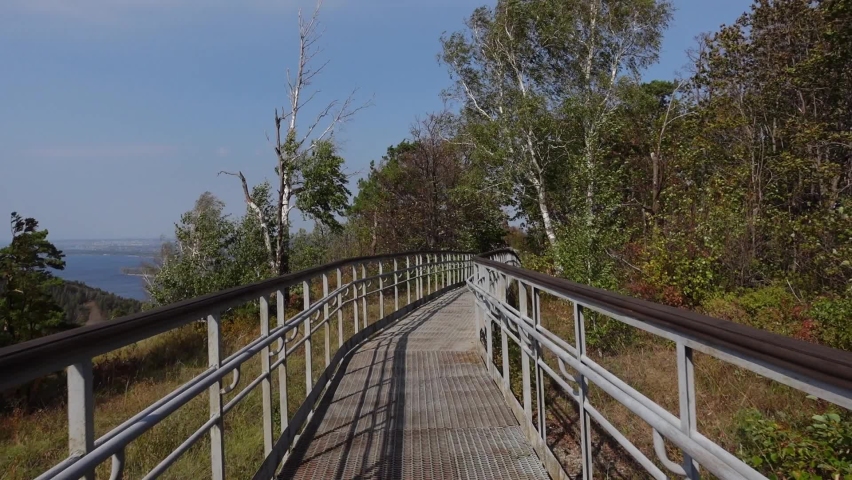 Walk along the equipped trail among the woods in the park. Hiking