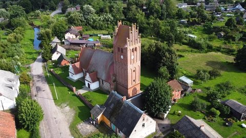 Kaliningrad, Russia, 19, August, 2021:
An old German church in the Gothic style in the suburbs of Kaliningrad, the Church of St. Anna, aerial view