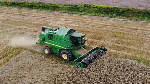 Kaliningrad, Russia, 13, August, 2021:
Harvesting ripe wheat on a field in Russia, a harvester harvests wheat, aerial view