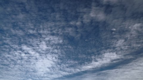 8K 7680x4320 4320p.Thin partly cloudy sky of a standard day.White tulle clouds on a blue background.Time lapse skies soft clear transition passage pass passing parts sunny cloudscape simple flat air.