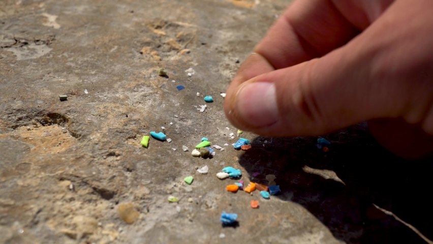Close-up shot of microplastics particles. The concept for water pollution and global warming. Climate change idea. Soft focus of micro plastic that cannot be recycled | Shutterstock HD Video #1090247595