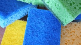 Yellow, green and blue sponges for washing dishes.