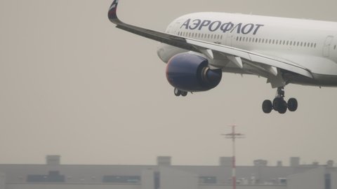 MOSCOW, RUSSIAN FEDERATION - JULY 28, 2021: Airbus A350 of Aeroflot landing in rainy weather at Sheremetyevo airport (SVO). Side view, airliner touching the wet runway during landing