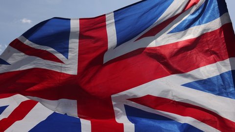 Closeup of United Kingdom flag Union Jack waving in the wind