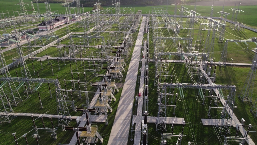 High voltage electrical substation. View from flying drone. Power plant with tall pylons and voltage distribution cables. Concept of energy, electricity industry, delivery and distribution of Royalty-Free Stock Footage #1090252789