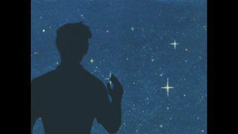 1960s: Silhouette of man in front of stars. Star shines brightly in sky. Man and boy stand outside with lamb, man talks, boy begins to leave, turns around and picks up lamb, walks across desert.