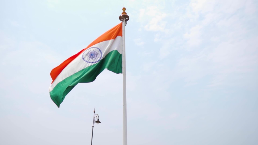 Slow motion shot of an Indian flag waving in front of the blue sky at Goa in India. Indian flag waving in the wind. Indian flag background. Indian flag waves in front of the blue sky during day time.  | Shutterstock HD Video #1090256181