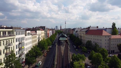 Pedestrians crossing the road e-scooter riders ride in bike lane car drive.
Gorgeous aerial view flight tilt down drone footage of Berlin Prenzlauer Berg Schönauer Allee Spring 2022 by Philipp Marnitz