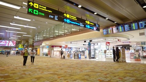 Singapore , Singapore - 05 10 2022: Few People In Mask Walking Inside The Changi Airport