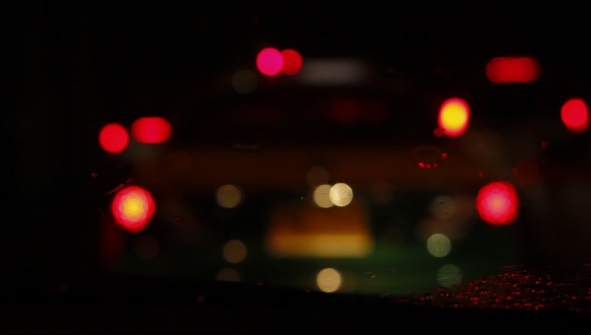 Wet mirror with the background of the night city traffic view. Royalty-Free Stock Footage #1090258989