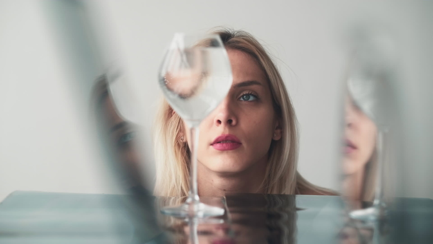Paranormal person. Telekinesis power. Psychic medium. Concentrated mysterious woman moving water glass with psychokinetic energy at mirror reflection. Royalty-Free Stock Footage #1090262093