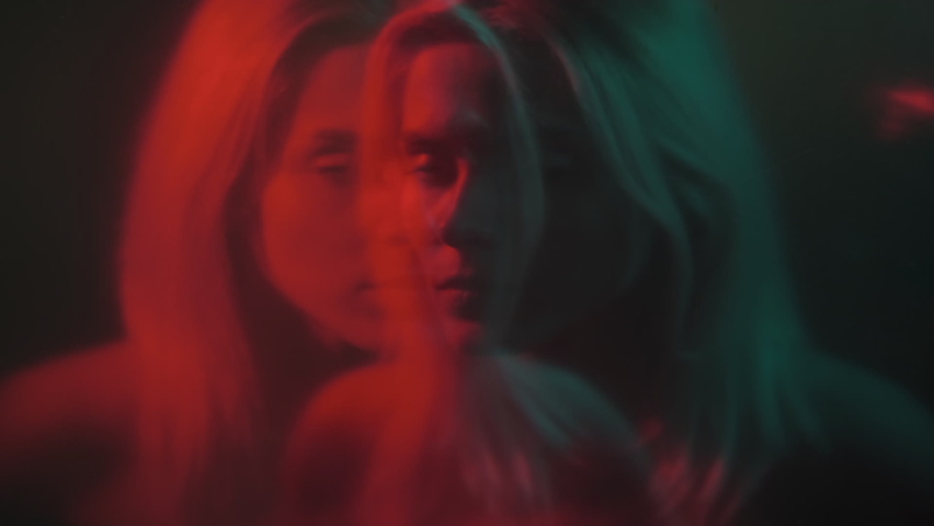 Panic attack. Scared woman. Anxiety problem. Night horror. Defocused double exposure of frightened female in red neon light on dark background out of focus. | Shutterstock HD Video #1090262107