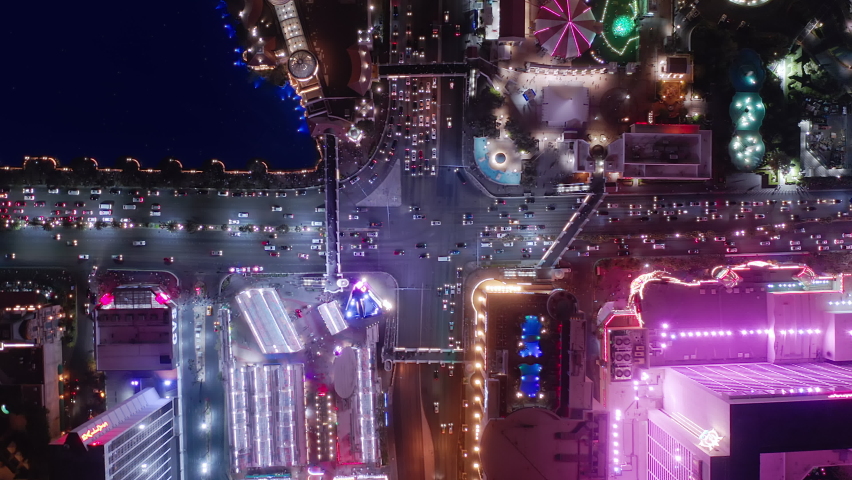 Drone Flight Over Urban Crossroads At Night Rush Hour Traffic. Night City Panorama, Las Vegas Business District at Low Light, 4k aerial colorful vibrant night scene. Las Vegas, Nevada, USA Apr 2022
