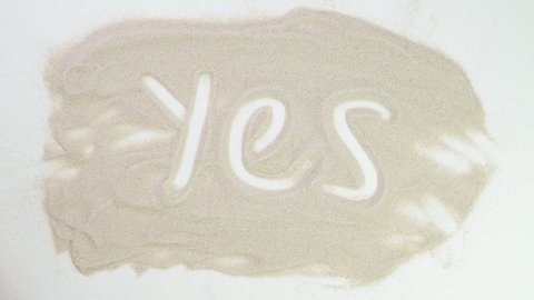 Yes I agree. consent. choice is positive. Top view draw on sand. Caucasian hands write text in beige sand. Vacation and travel. Beach on vacation. Sand painting. Creativity from natural materials.