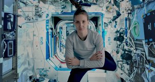 Female astronaut waving to camera inside the International space station. ISS. Some elements of the video furnished by NASA