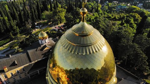 Drone view of the beautiful Orthodox New Athos Monastery with golden domes in the city of New Athos, Abkhazia. In the center of the temple complex stands the Panteleimon Cathedral