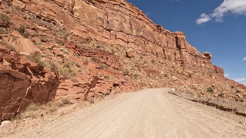 Moki Dugway Utah desert mountain POV part 1. Roadway carved from a mountain cliff. Scenic Backway a stretch of Highway 261 switches down the side of a cliff is an 11% grade and very narrow.