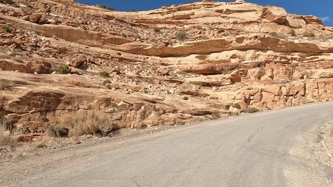 Moki Dugway Utah cliff mountain POV 4K. Roadway carved from a mountain cliff. Scenic Backway a stretch of Highway 261 switches down the side of a cliff is an 11% grade and very narrow.